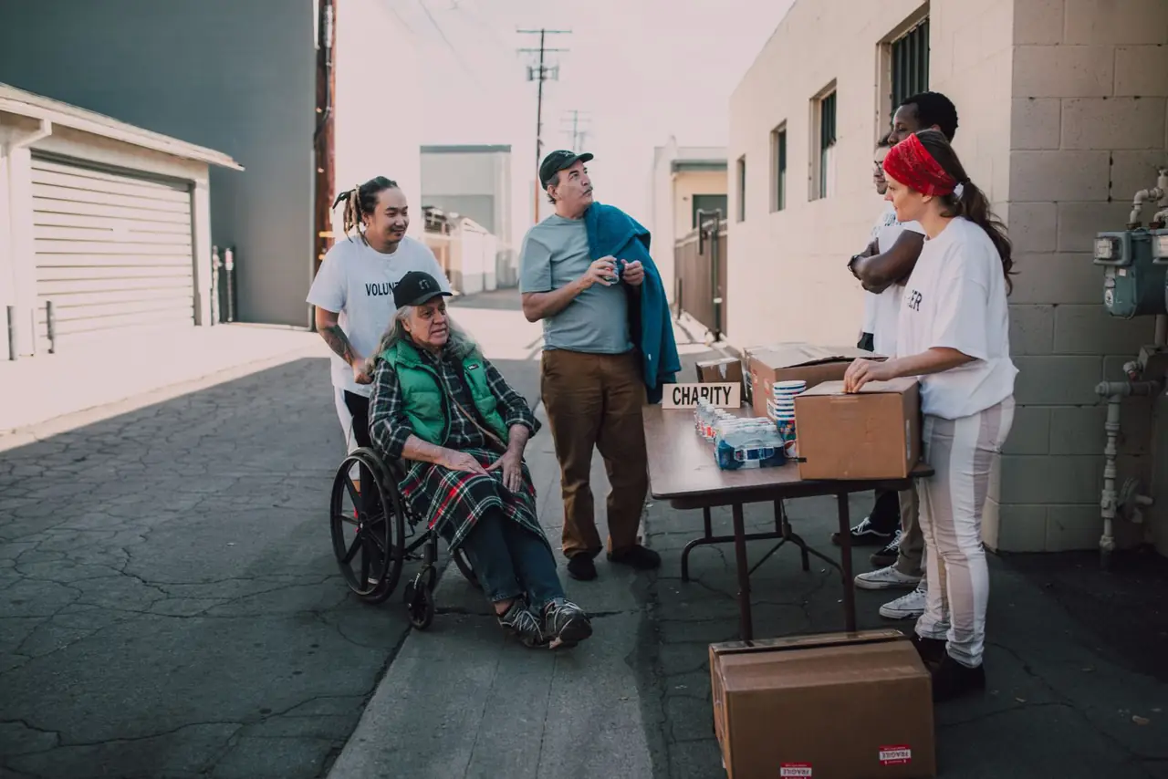 Volunteers handing out supplies from a table on a street